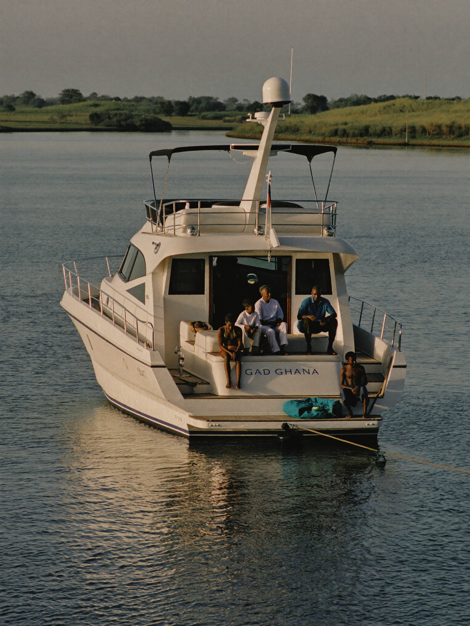 A yacht anchored on calm water at Ada at golden hour